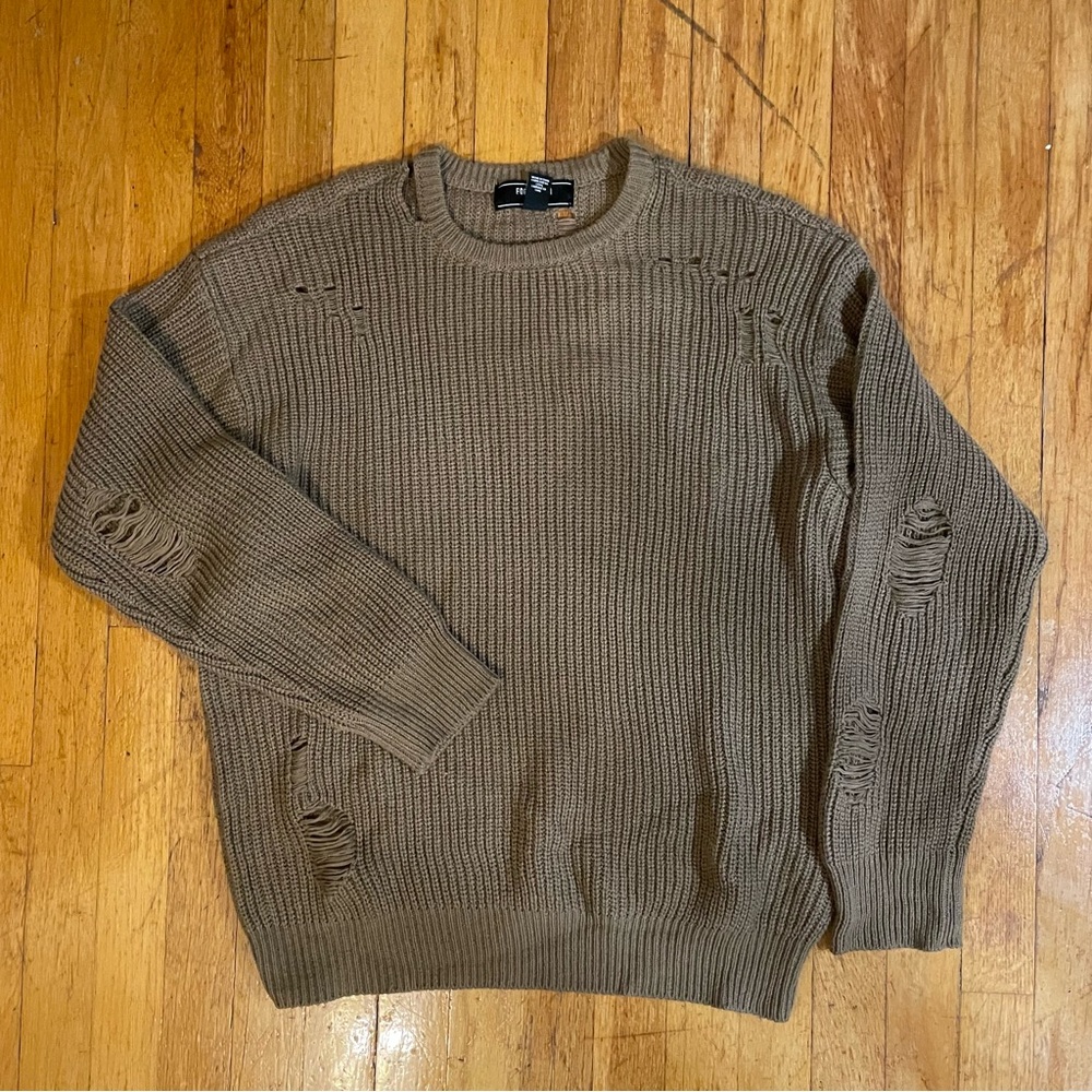 Tan ribbed knit sweater with purposeful defects